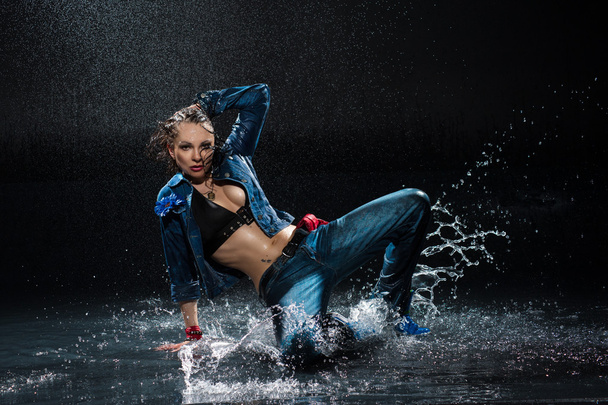 Wet dancing woman. Under waterdrops. Studio photo - Photo, image