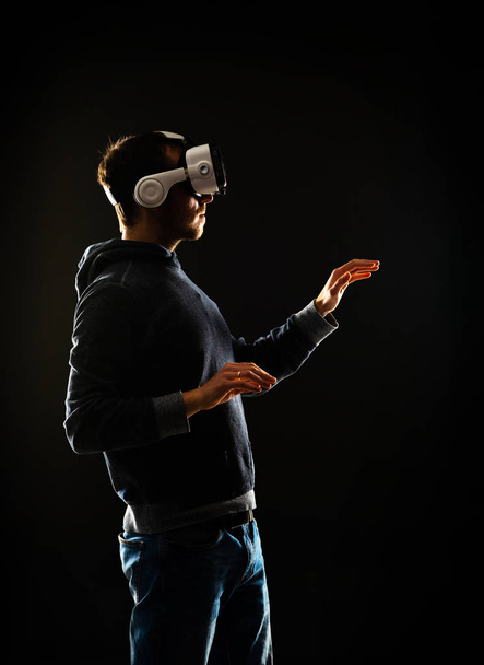 Portrait of computer hacker in virtual reality headset. Man in VR helmet. Data thief, internet fraud, darknet and cyber security concept. - Photo, image