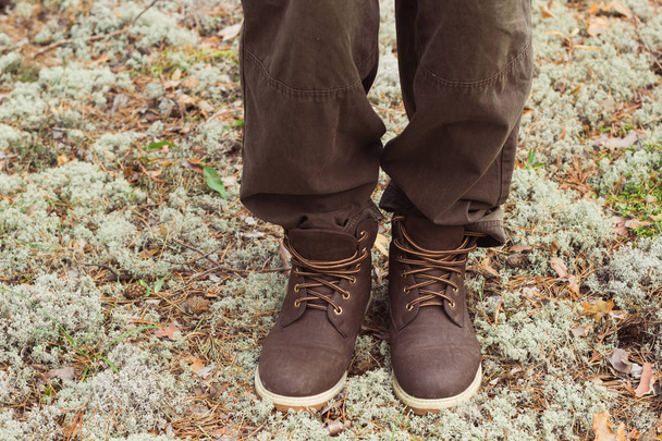 чоловік мандрівник ноги в шкіряних чоботях в лісі
 - Фото, зображення