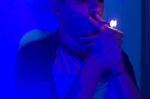 man with cigarette in neon light - Photo, image