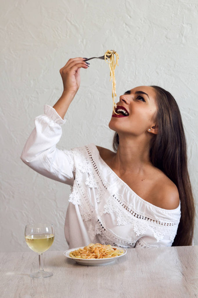beautiful young woman eating pasta portrait - Photo, Image