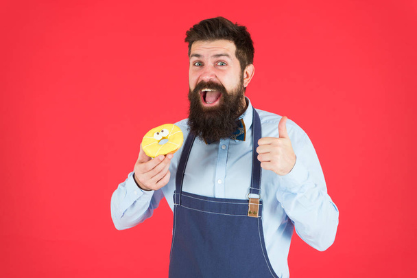 baker hold donut. Funny hipster. Sweet donut. Chef man in cafe. Diet and healthy food. Doughnut diet. Calorie. Feel hunger. Perfect donut. Bearded man in apron. Donut food. I love my job. - Foto, Imagen
