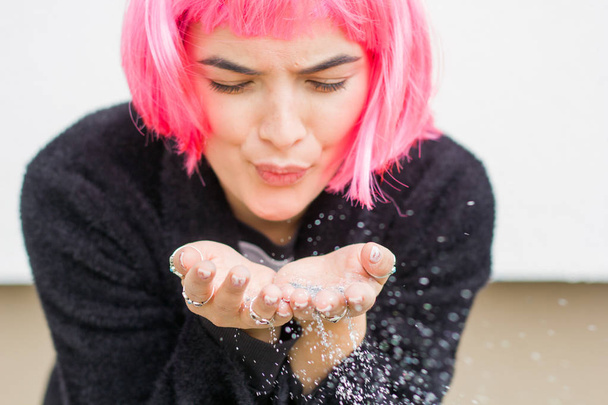 portrait of a woman in pink wig with silver sequins in her hands - Foto, Imagen