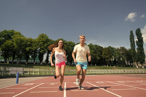 Couple running on arena track - Foto, imagen