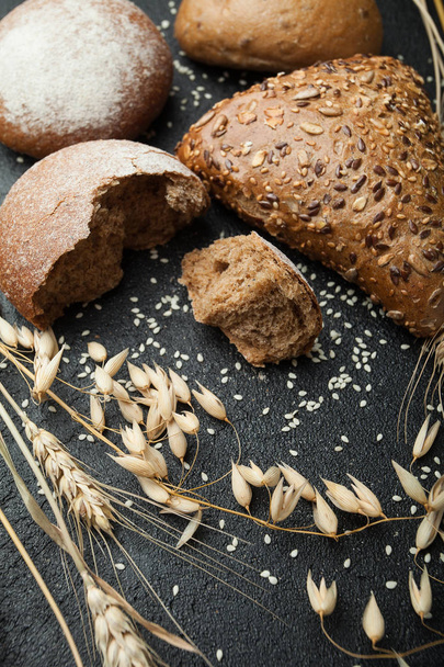 Homemade dark rye bread sprinkled with flour and various grains  - Photo, image