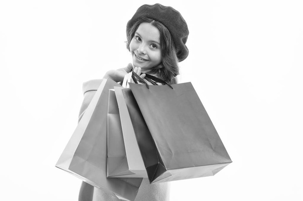 Heavy bags. Small girl with shopping bags. Little shopper. Small child with paper bags. Girl child enjoy shopping. Little shopaholic with paperbags. Shopping is an addiction - Foto, afbeelding