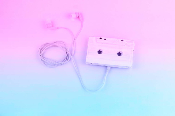top view audio cassete tape and earphones pastel blue and pink gradient toned flat lay - Photo, Image