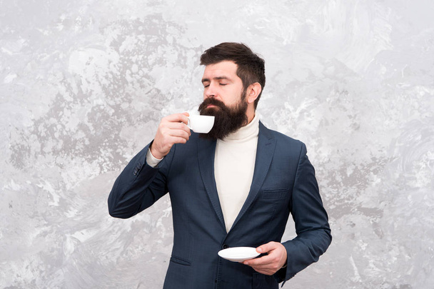 Best coffee served for him. Specialty coffee. Man handsome bearded businessman hold cup of coffee. Coffee break concept. Business people fashion style. Smart casual style clothes for office life - Fotó, kép