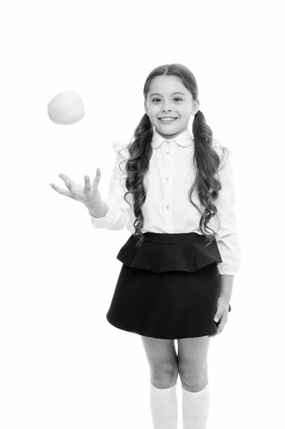 Detox and diet. Healthy nutrition diet. Girl pupil hold apple fruit on white background. Kid happy hold apple. School snack concept. Apple vitamin snack. Schoolgirl wear formal uniform hold apple - Photo, Image