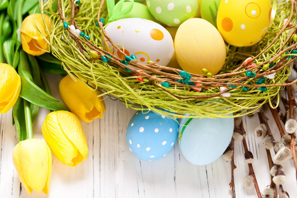 Happy Easter. Congratulatory easter background. Easter eggs and flowers. Selective focus. Top view. - Foto, immagini