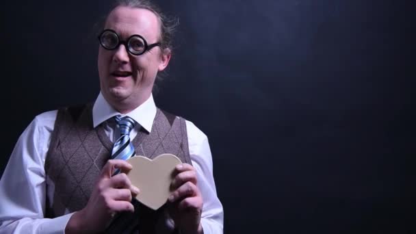 Amorous nerd with a heart as a gift - Footage, Video