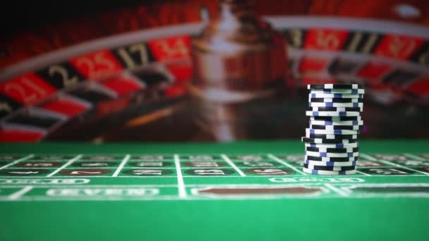 Chips on green felt casino table. Abstract background with copy space. Gambling, poker, casino and cards games theme. Casino elements on green. Selective focus - Footage, Video