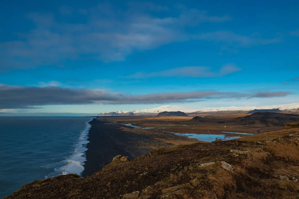 View of the black beach and the mountains from the cliff Dyrholaey. Iceland. - Photo, Image