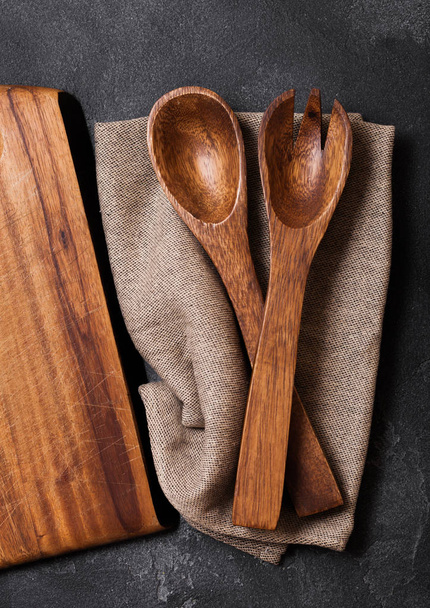 Vintage kitchen wooden utensils with chopping board on stone table background. Top view. Space for text - Фото, зображення