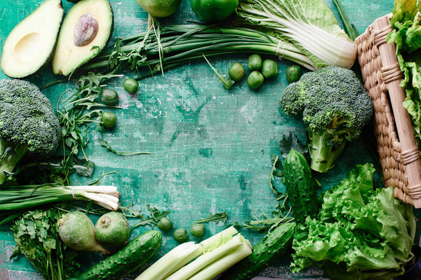 Frame of fresh vegetables and fruits and greens on a green shabby background. Healthy eating concept - Foto, Bild