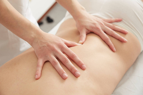 Female Enjoying Relaxing Massage In Cosmetology Spa Center - Фото, изображение