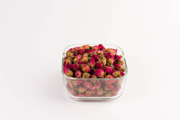 tea rose buds in a glass drinking bowl  isolated on white  background - Fotó, kép