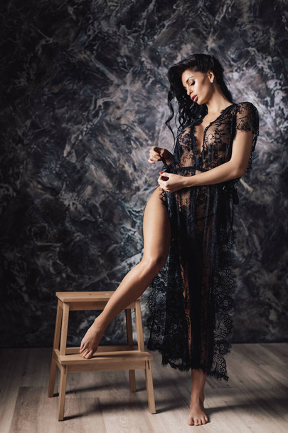 Sexy woman in lace black sensual robe with long curly hair - Valokuva, kuva