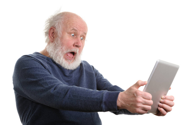 Funny shocked senior man using tablet computer isolated on white - Photo, Image