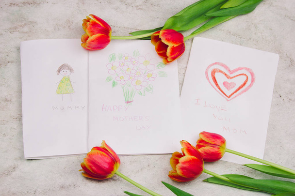 beautiful tulips and handmade card with kid's drawing  for Mother's Day on marble background, top view - Valokuva, kuva
