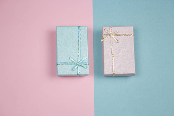 top view blue gift box on a pink background and pink gift box on a blue background creative festive  flat lay - Fotó, kép