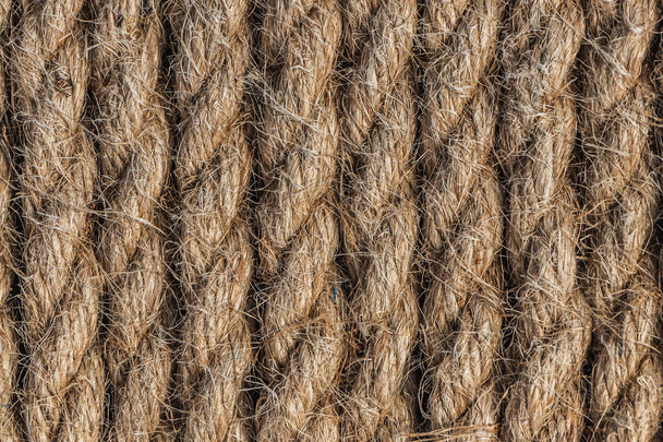 A beautiful horizontal pattern texture from yellow natural flax rope on dark background - Photo, Image