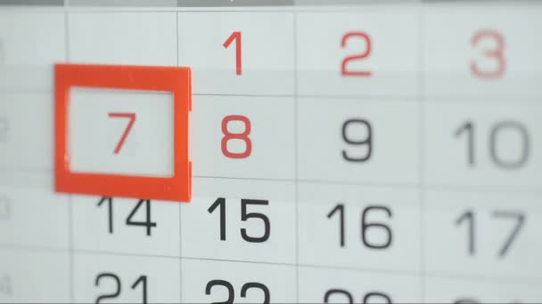 Womans hand in office changes date at wall calendar. Changes 6 to 7 - Footage, Video