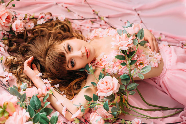 image of spring, sweet and gentle lady in long gorgeous pink dress looking directly at camera, portrait photo with wonderful work of makeup artist and hairdresser, a girl like a rose flower - Photo, image