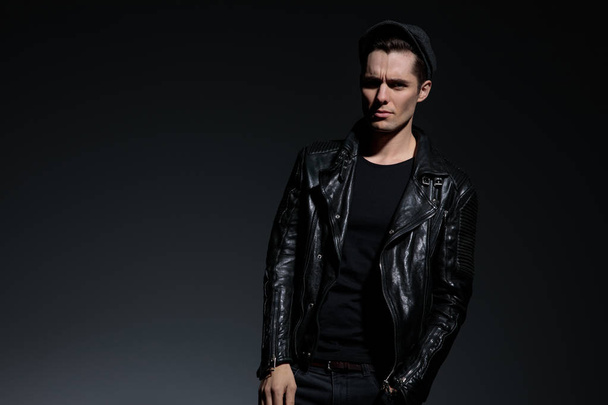 young fashion man in leather jacket looking upset - Photo, Image