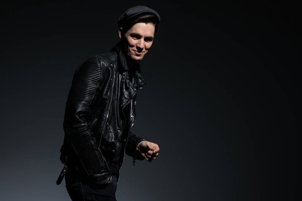 laughing young fashion man in leather jacket and hat - Photo, Image