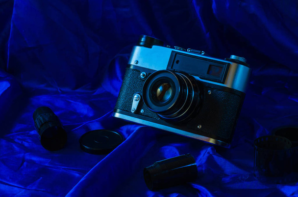 Photo film and film camera on a wooden table. - Фото, зображення