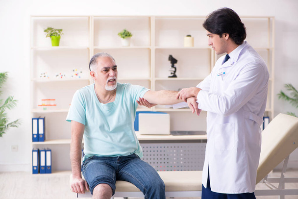 Old man visiting young male doctor  - Photo, Image