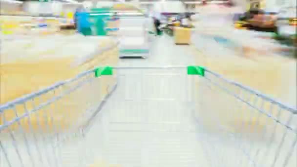 Час Лапсе Кошик рухається між різними островами і секцією у великому супермаркеті. Всередині візка різні здорові предмети і зручність Їжа
. - Кадри, відео