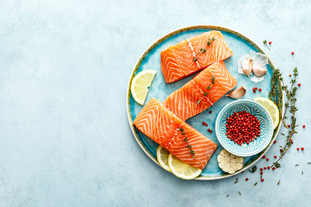 Seafood. Fresh raw salmon or trout fillets with ingredients, top view, space for a text - Φωτογραφία, εικόνα