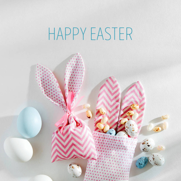 Easter Bunny bags with treats, candy, chocolate eggs on white background. Happy Easter concept. - Foto, Imagem