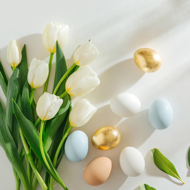 White tulips and Eggs  with sunlight on white background. Stylish spring Compositions. Easter concept. - Fotografie, Obrázek