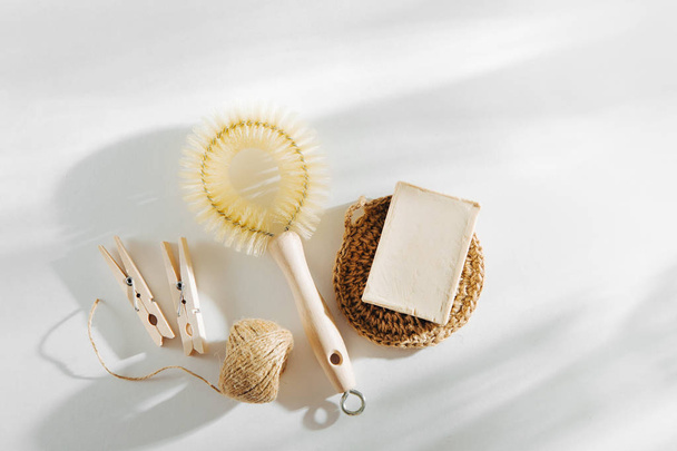 Natural dish brush, wooden clothespin and cleaning tools with Soap. Zero waste concept. Plastic free. Flat lay, top view  - Fotó, kép