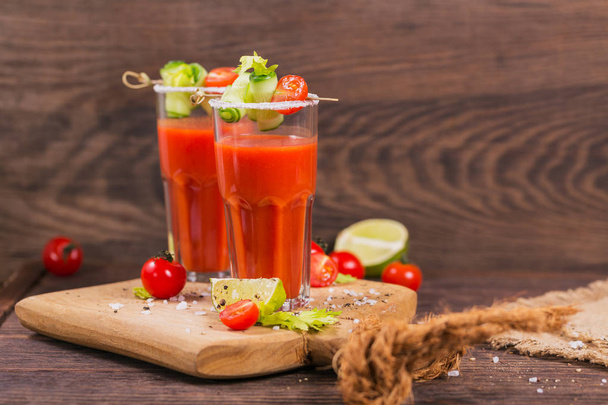 Two glasses of tomato juice decorated with fresh tomatoes, cucum - Photo, Image