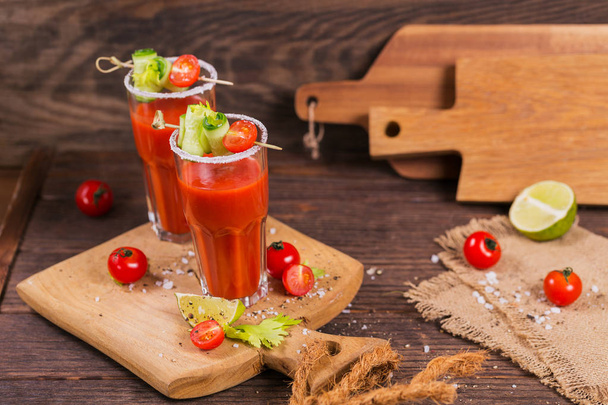 Two glasses of tomato juice decorated with fresh tomatoes, cucum - Foto, Imagen
