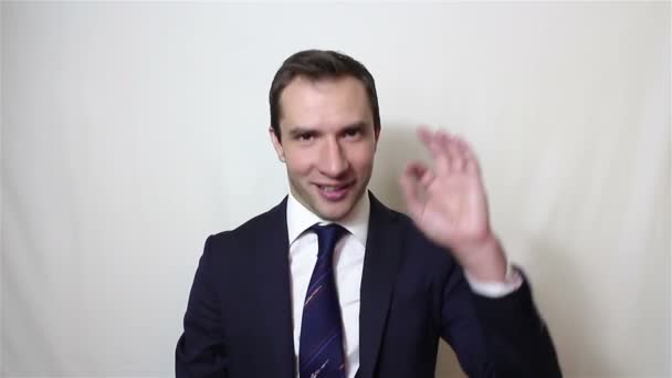 Young handsome businessman says ok and shows gesture ok - Materiaali, video