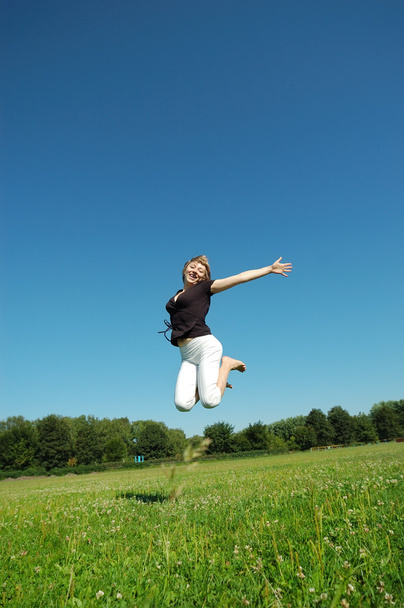 Jumping young happy girl - Photo, Image