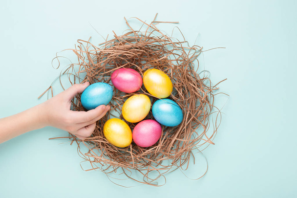 Easter eggs on turquoise background. - Foto, afbeelding