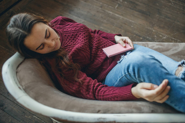 Young woman sleeping on sofa with her diary - Φωτογραφία, εικόνα