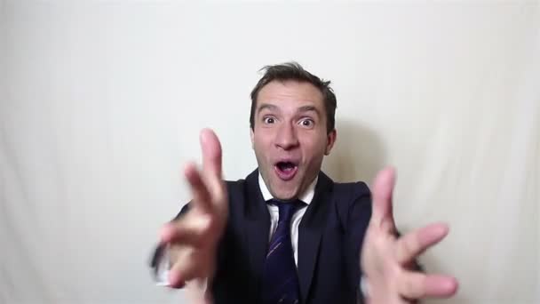 Handsome young businessman actively expresses joy clapping and loud laughing - Materiaali, video
