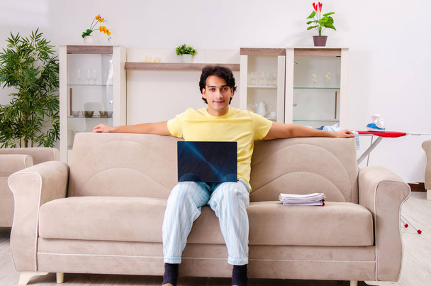 Young man husband ironing at home  - Fotó, kép