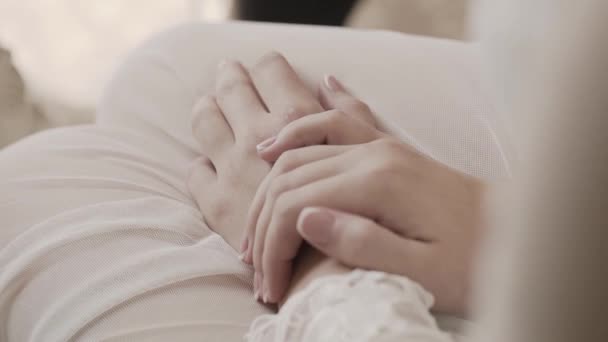Beautiful hands of a young woman on her knees. - Video, Çekim