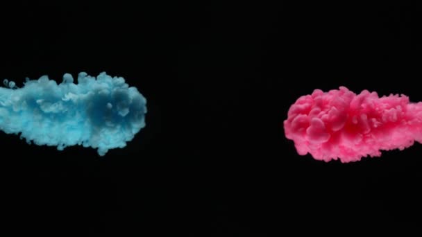 Super slow motion of coloured inks in water. Isolated on black background. Filmed on high speed cinema camera. - Footage, Video