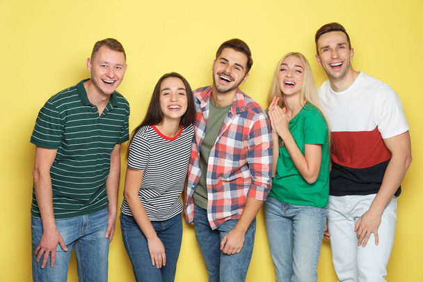 Group of friends laughing together against color background - Foto, Imagem