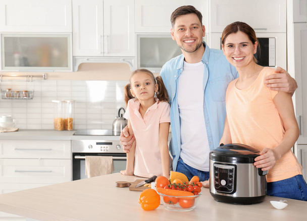Happy family with modern multi cooker in kitchen - Foto, Imagem