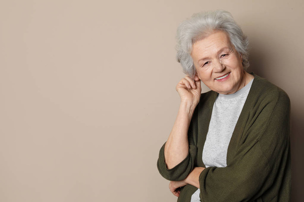 Portrait of mature woman on color background. Space for text - Φωτογραφία, εικόνα